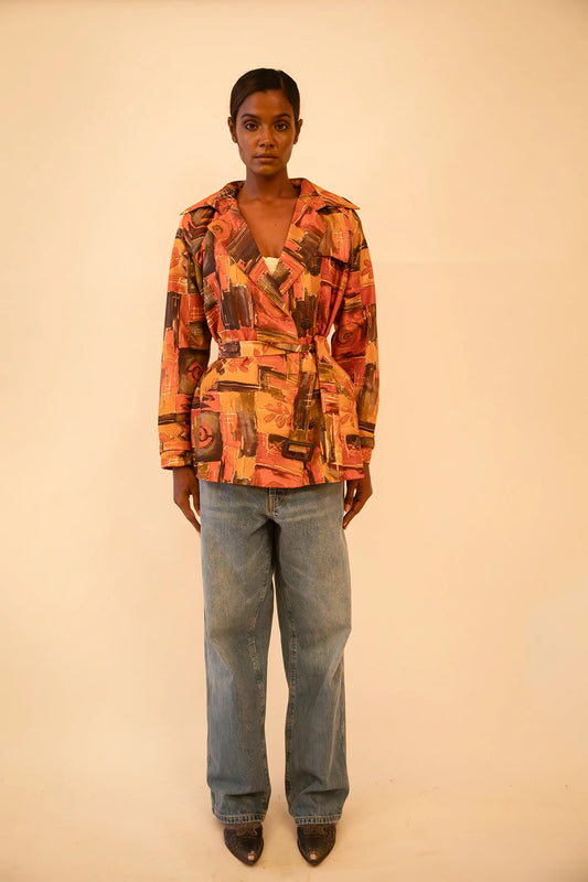 Cropped trench coat crafted from upcycled abstract print silk, featuring a relaxed fit and lightweight structure.