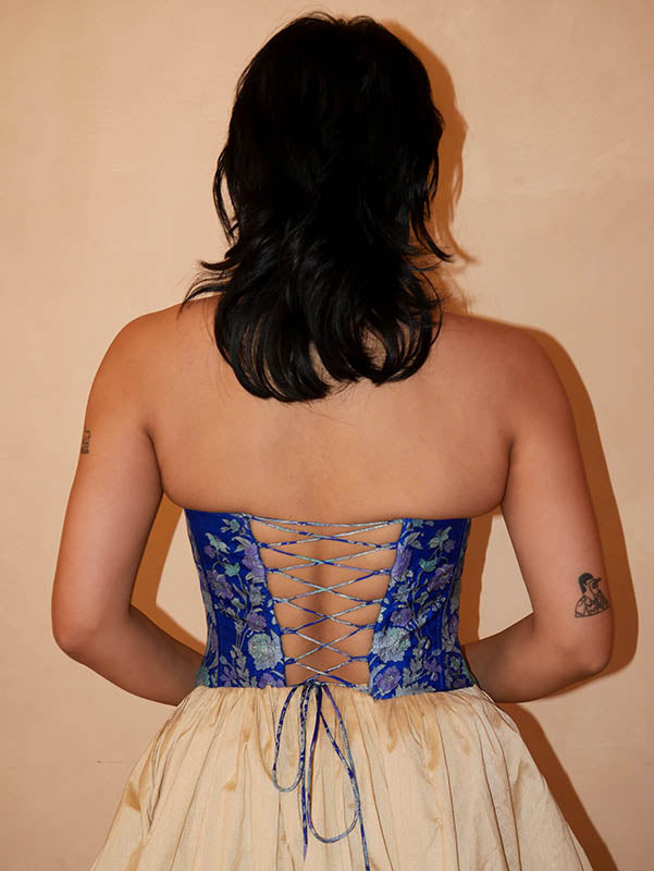 four-panel corset crafted from a vintage pink silk sari, featuring V-cut detailing and adjustable lace-up panels, consciously handcrafted by Bodements to celebrate heritage, craft, and mindful fashion.