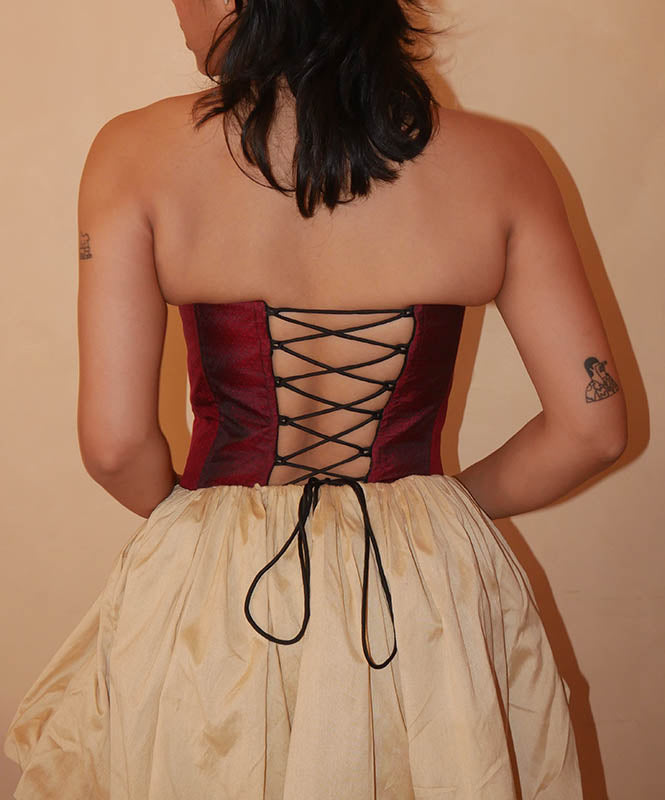 four-panel corset crafted from a vintage Maroon silk sari, featuring V-cut detailing and adjustable lace-up panels, consciously handcrafted by Bodements to celebrate heritage, craft, and mindful fashion.