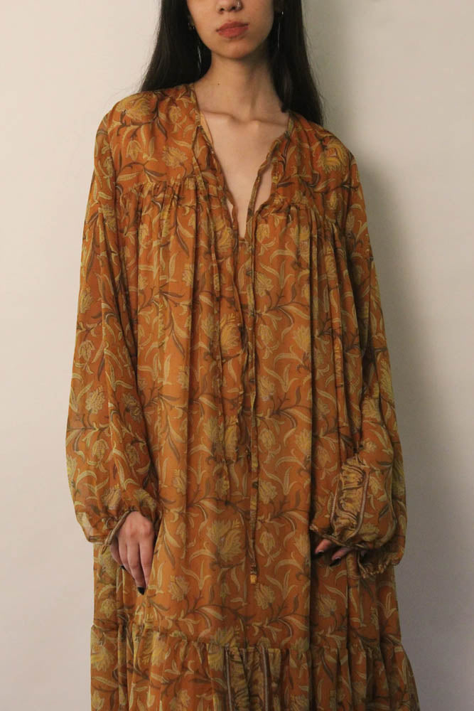 SAIA vintage silk maxi dress in black with beige floral motifs, flowy silhouette, versatile deep V or tied neckline, and elastic cuff long sleeves.