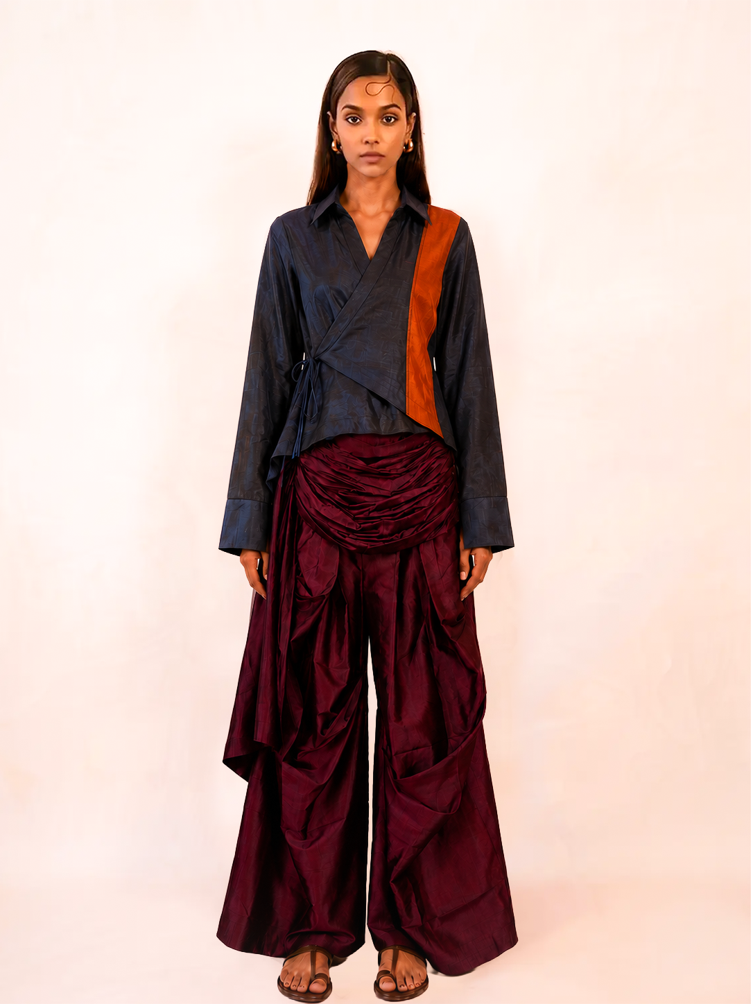 VASTRAM is our one-of-a-kind loose-fitting outer tunic, handcrafted in-house with a layered, asymmetrical fall and patched full sleeves.