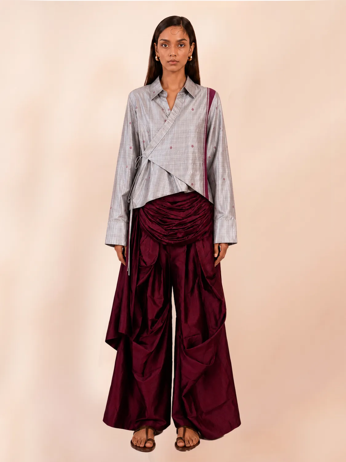 VASTRAM is our one-of-a-kind loose-fitting outer tunic, handcrafted in-house with a layered, asymmetrical fall and patched full sleeves. 