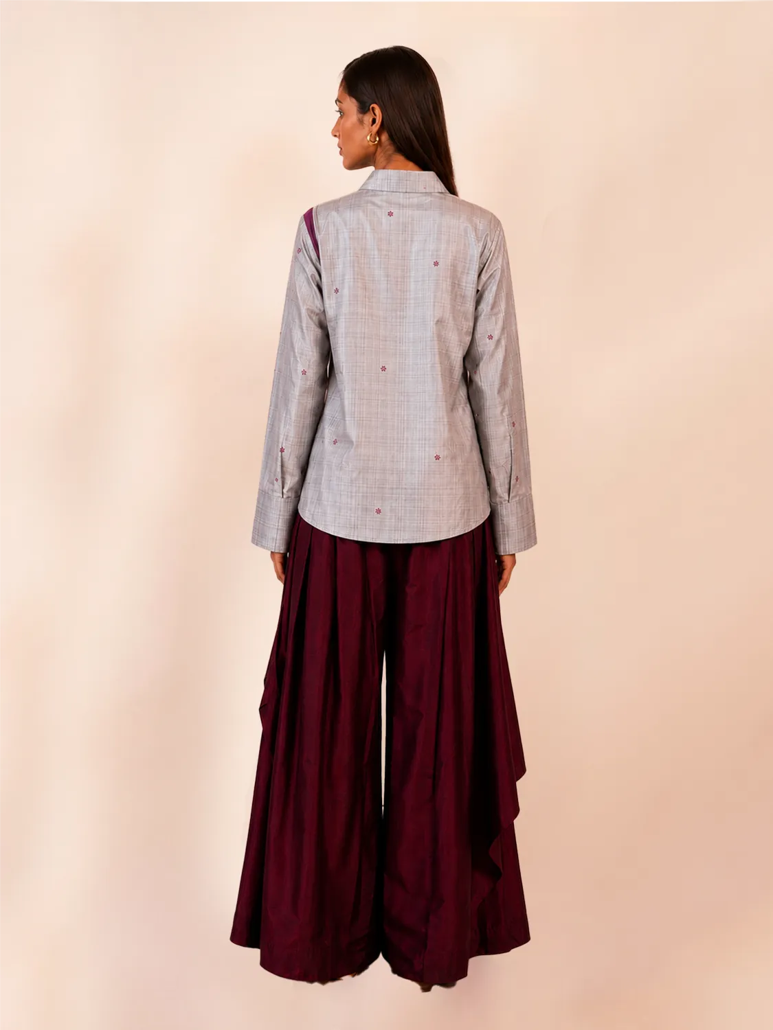 VASTRAM is our one-of-a-kind loose-fitting outer tunic, handcrafted in-house with a layered, asymmetrical fall and patched full sleeves. 