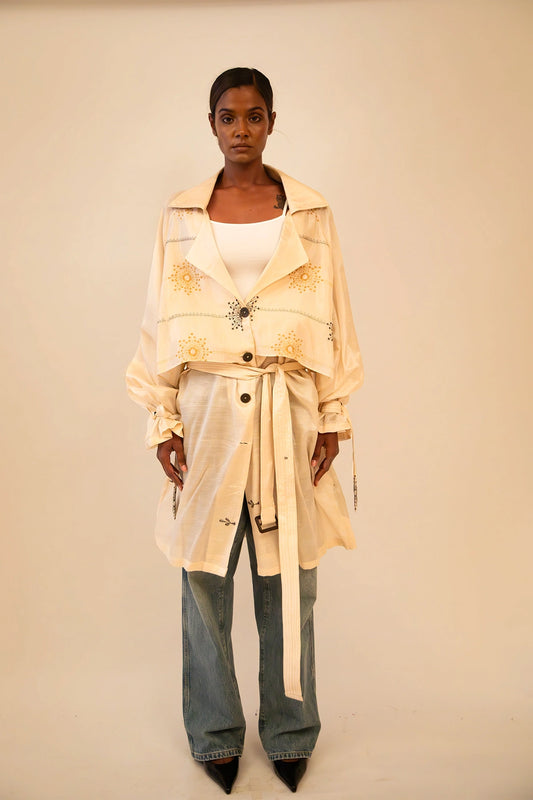 Off-white vintage trench coat without lining, featuring a relaxed fit and lightweight drape, ideal for layering and conscious styling.
