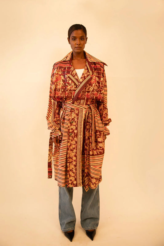 Rust-colored silk trench coat crafted from vintage fabric, featuring a relaxed fit, self-tie belt, and no inner lining, celebrating lightweight layering and conscious design.