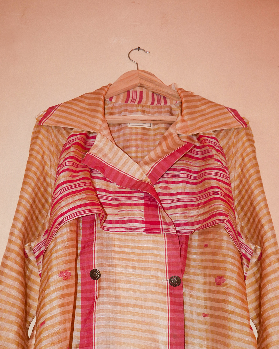 VEDYA IX is our one-of-a-kind pink and white silk trench coat, handcrafted in-house using a vintage silk saree. 