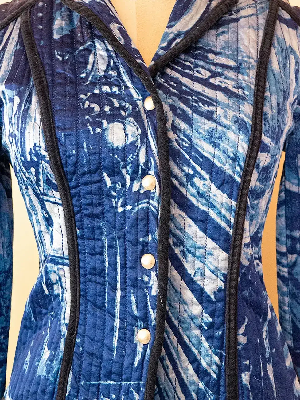 Vintage Gattinoni blue quilted jacket featuring contrast piping and structured tailoring, sourced from global designer archives.