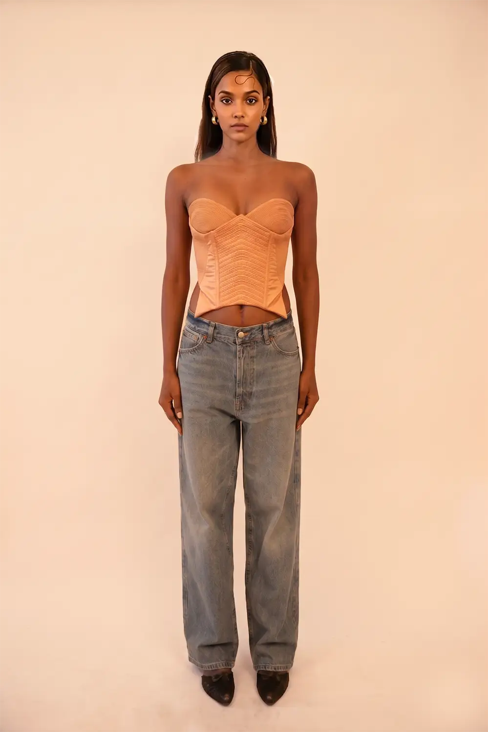 VANA is our one-of-a-kind silk corset, handcrafted in-house using a vintage silk saree. The structured silhouette features intricate hand-done cording details, allowing for a cinched yet refined wear that beautifully adds depth and dimension to the body. Vana is a quiet reflection of meticulous craftsmanship and intentional design.