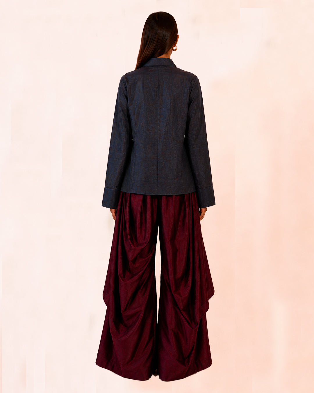 VASTRAM is our one-of-a-kind loose-fitting outer tunic, handcrafted in-house with a layered, asymmetrical fall and patched full sleeves. 